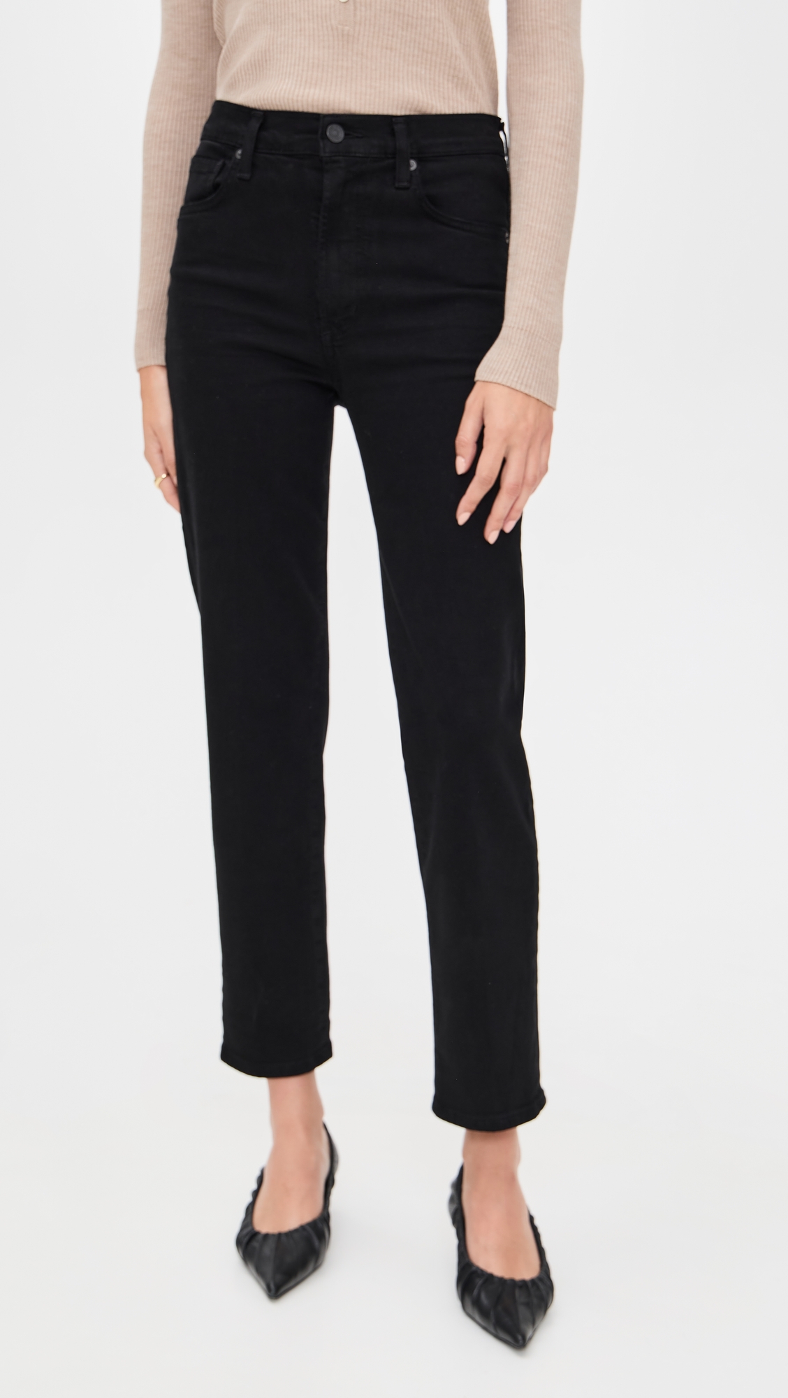 Black high-rise straight jeans styled with pointed pumps