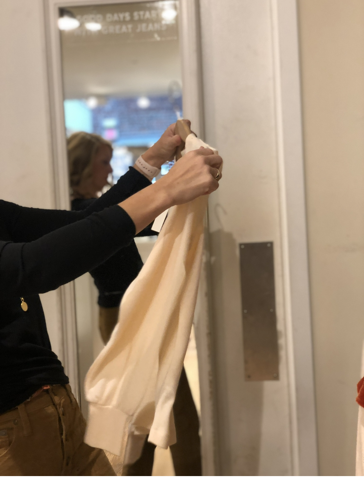 Wendy Pilch styling a garment in a fitting room