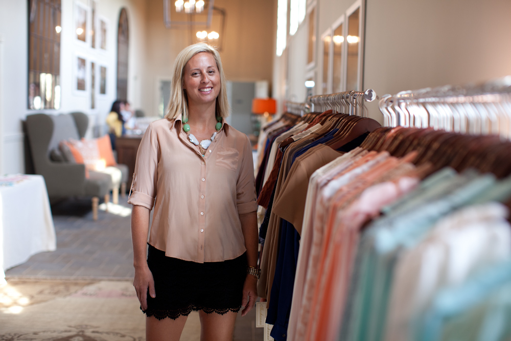 Wendy Pilch standing beside racks of clothing in a boutique
