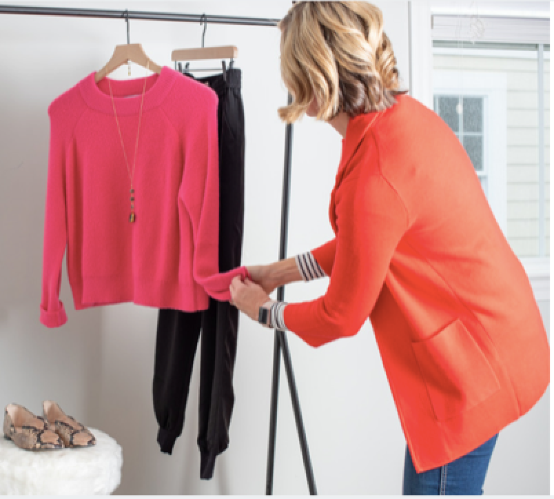 Wendy Pilch styling a pink sweater in a bright studio