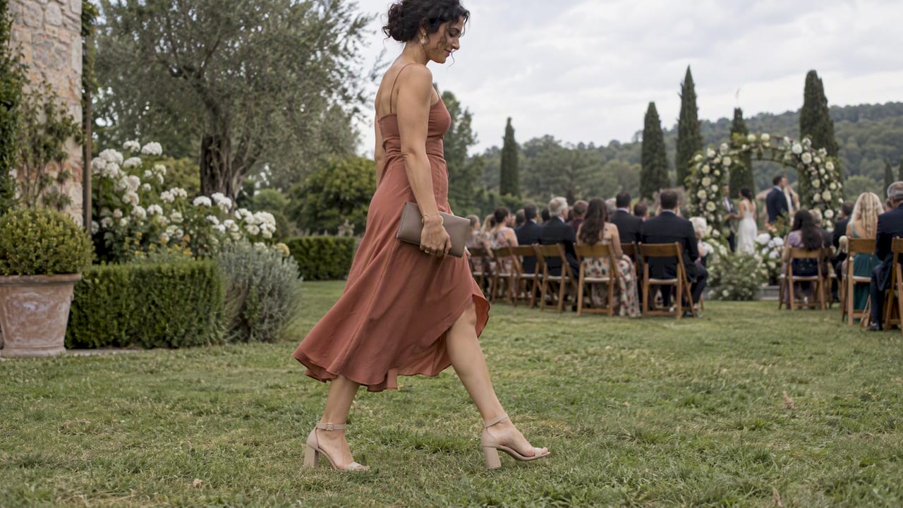 Block heels worn across a wedding lawn